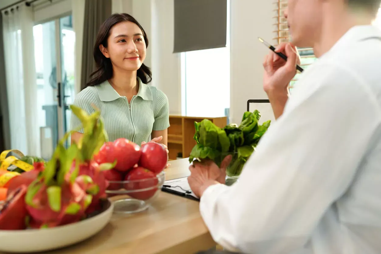 Woman and man discussing food products at a desk